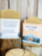 2 bars of soap sitting on pieces of wood in front of a wood background.