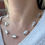 Thumbnail: Model wearing our Ice inspired Reflection Beaded Necklace