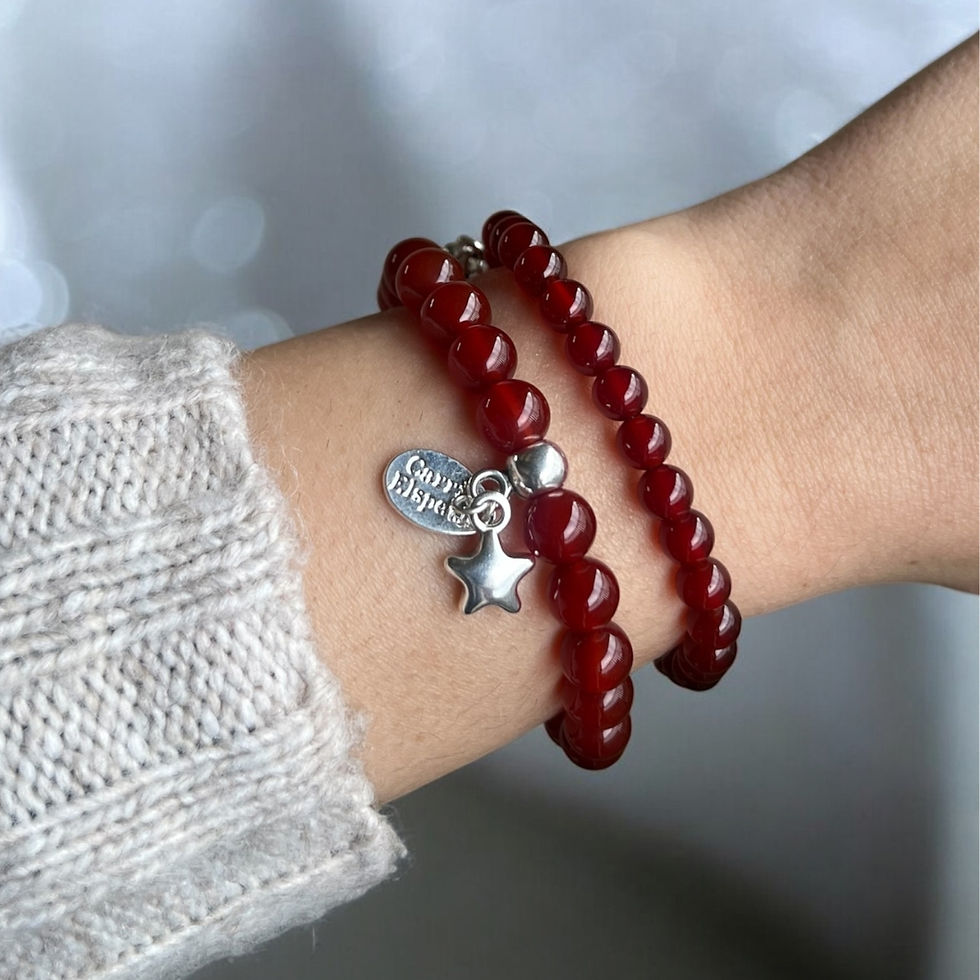 Thumbnail: Model wearing 6mm and 8mm Carnelian gemstone bracelets with star charm