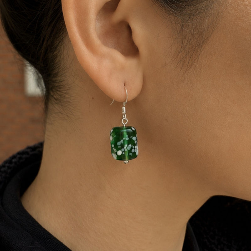 Thumbnail: Model wearing ocean spray earrings in dark green