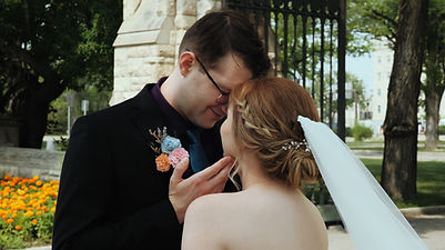 Bride and groom standing with foreheads together
