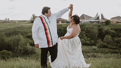 Bride and Groom dancing at a peak overlooking a valley