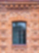 The window of the old mansion 19 century with brown bricks wall Brick wall of an old 19th
