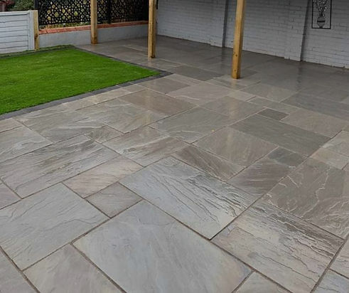 a grey sandstone patio landscaped