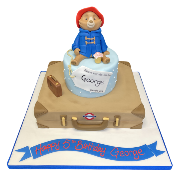 Delightful Paddington Bear-themed cake in the shape of a suitcase, perfect for fans of the beloved character. Ideal for birthdays and special occasions in UK.