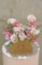 White roses, pink spray roses and orchids with greenery in tweed floral bag by Lena's Floral Designs, handmade in Toronto.