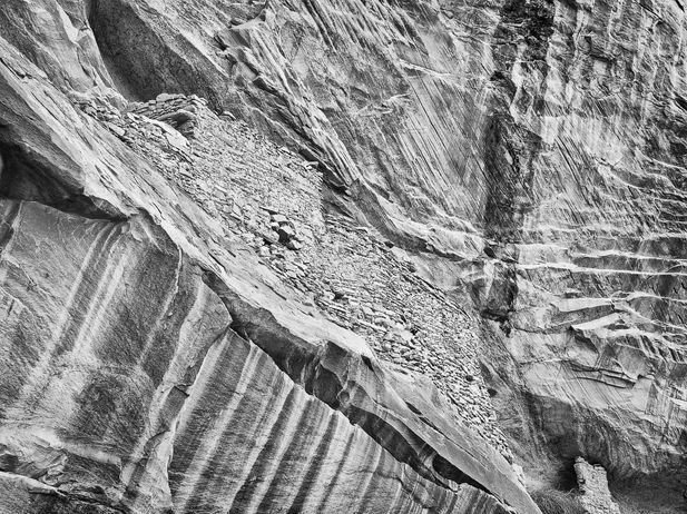 B&W photo of ancient masonry structures in alcove of Comb Ridge, Bears Ears National Monument.