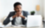 BIPOC professional thinking critically at computer