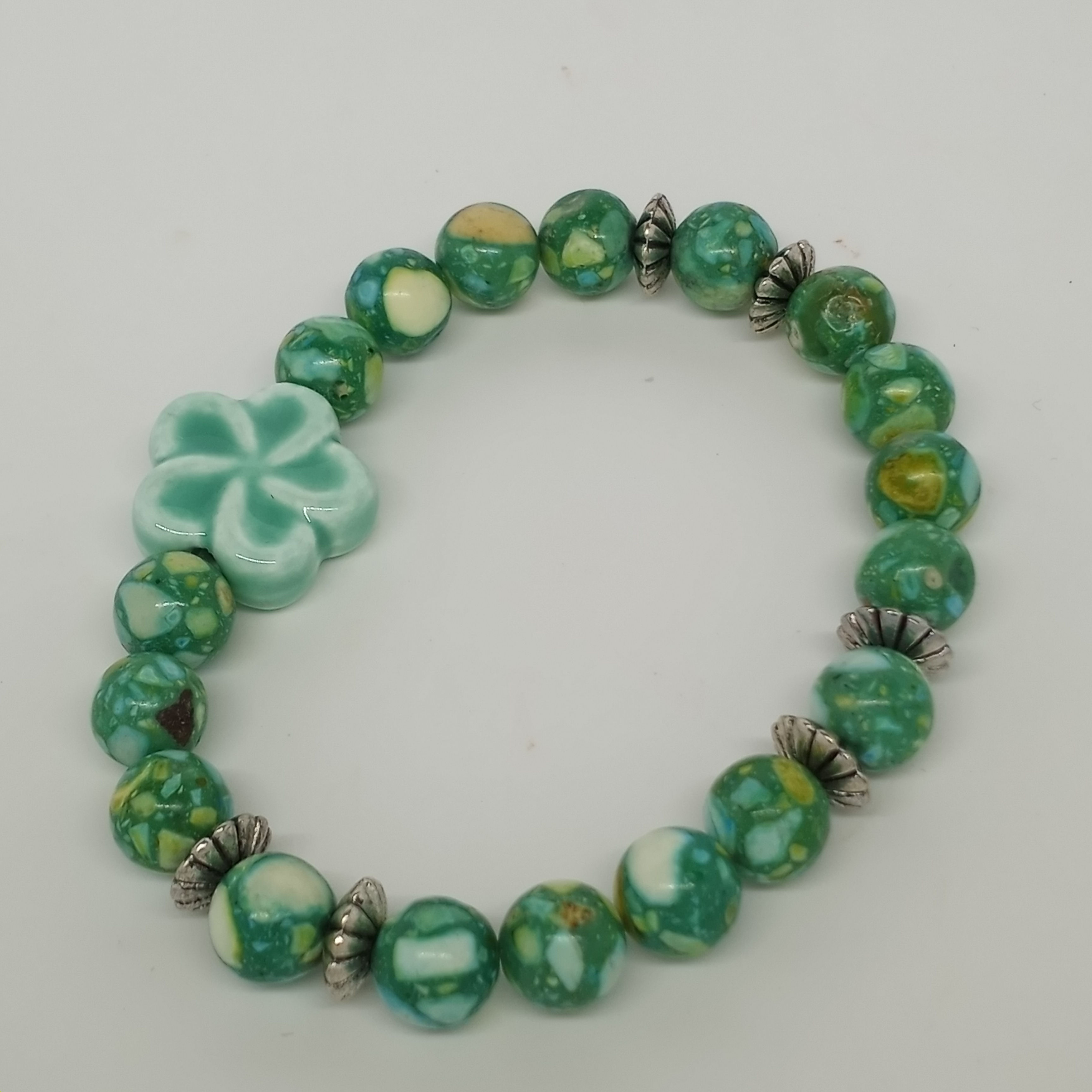 7 inch 8mm sea green howlite bracelet with porcelain flower accent