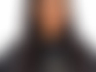 Woman with long straight black hair wearing an Auguste Beauty salon cape