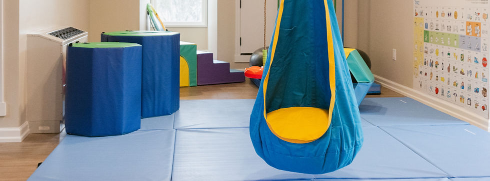 Pediatric sensory gym with sensory swings, climbing equipment, and jumping activities at Clear Path Pediatric Therapy in Mechanicsburg PA