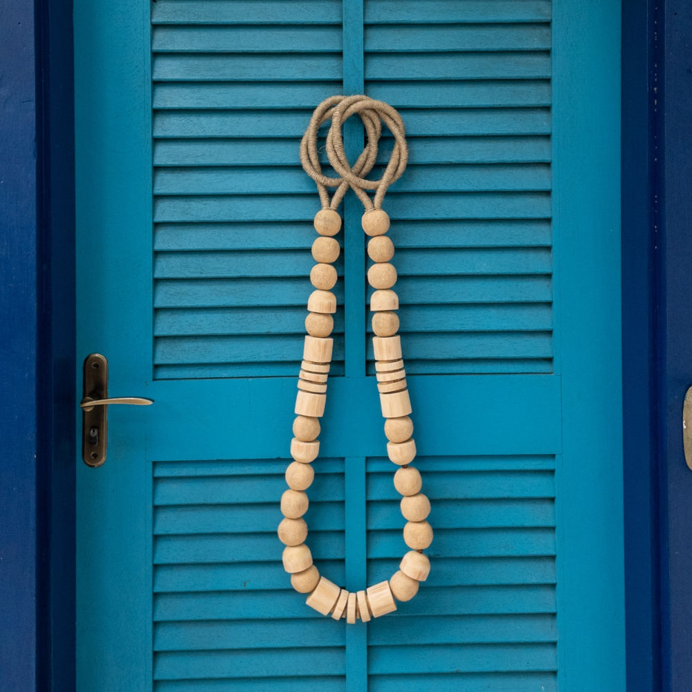 Decorative Dry Wood Necklace Wall Hanging deco in a blue front door.