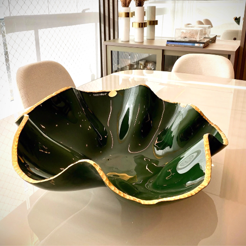 Large Forest Green, Gold Edge, Art Glass Bowl  on a round table.