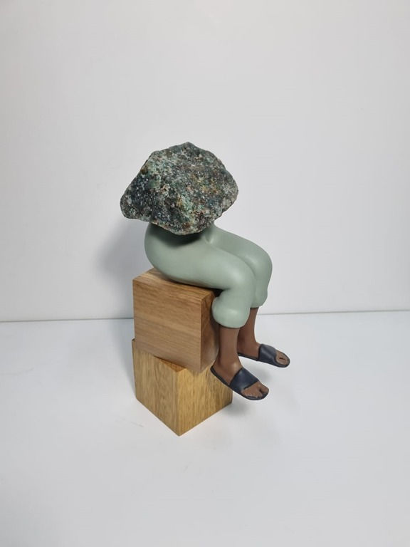 Thumbnail: Salvador A.'s sculpture incorporating natural gemstones into wooden design.