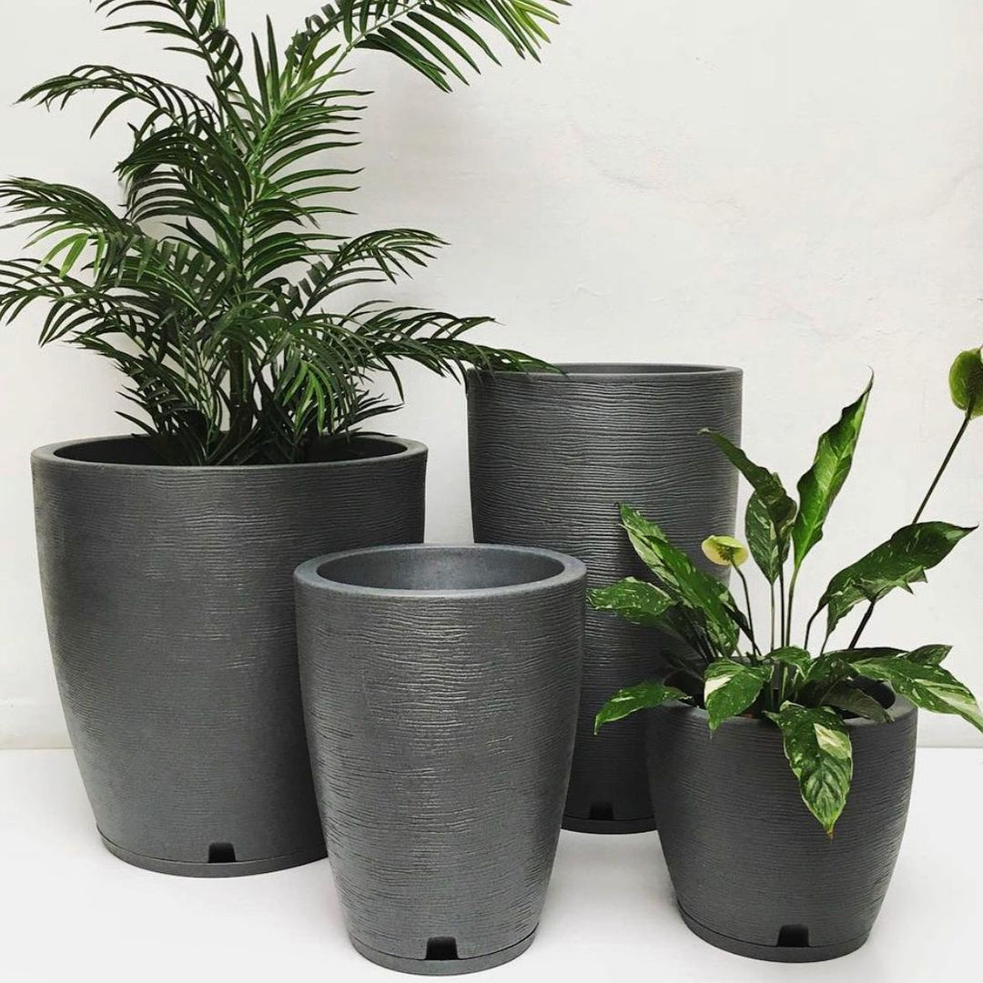 Set of large plant pots amsterdã line made of HDPE, color black with plants.
