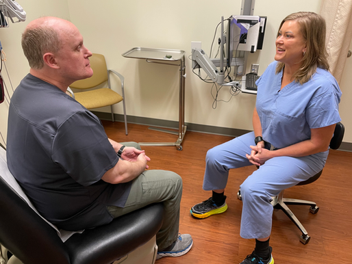 Dr. Kelly Morgan consulting with male patient about vasectomy cost and pricing in Eugene Oregon