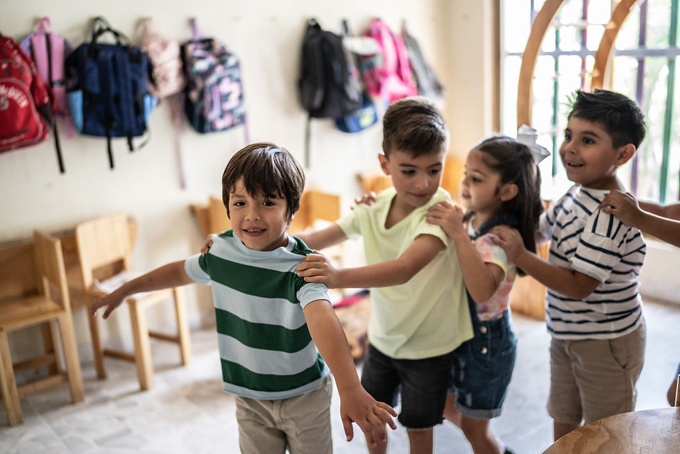 Pre-K children dancing together in a classroom.