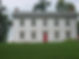 Historic white farmhouse with red door