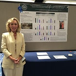 photo of dr. teri chenot standing in front of their presentation at the 2015 qsen national forum.
