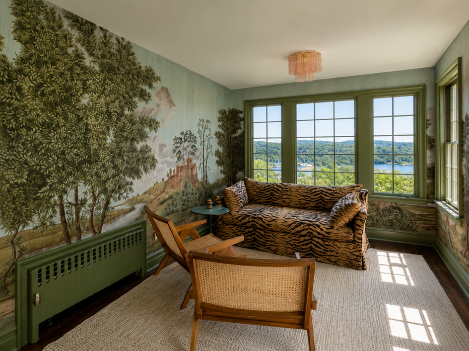 Elegant lounge space with custom mural wallpaper and green trim details.