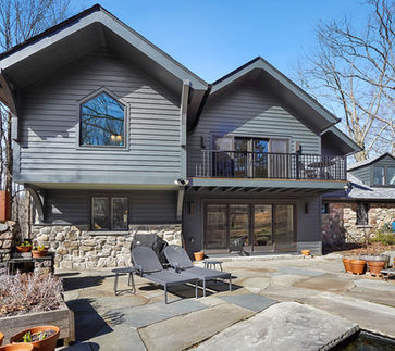Luxury home addition by Peluso Construction featuring custom stone, dark siding, expanded living space, and high-end exterior renovation in Rockland County NY.