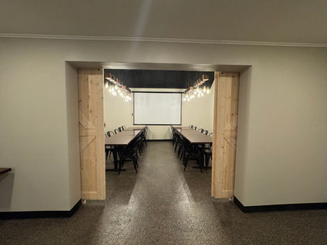 Sliding wooden doors between private rooms can be open to create a larger space for bigger groups and events