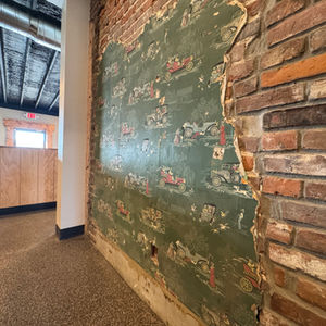 Original Wallpaper and brick maintained in the renovated space