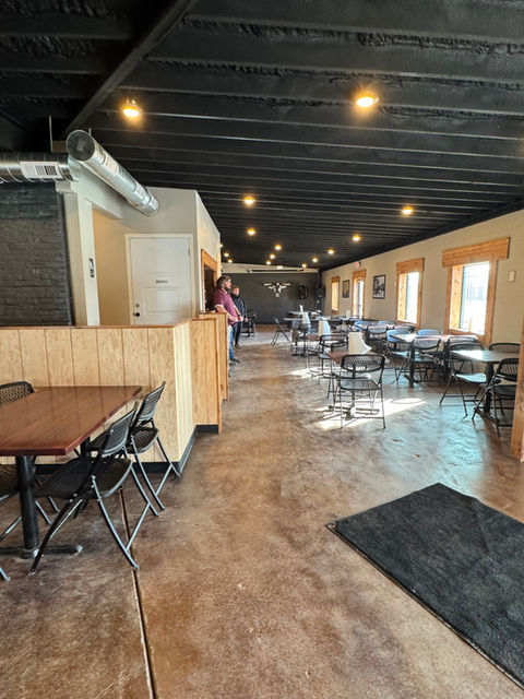 The newly remodeled building features stained concrete floors, exposed natural wood and brick