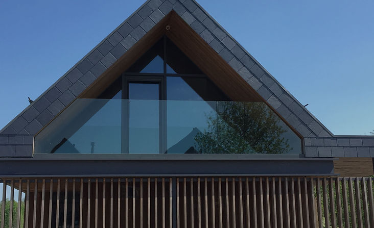 modern house with triangle shaped aluminum windows and rails