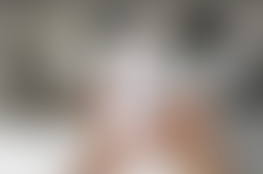 Hands hold a phone showing a video call with an AI therapist.