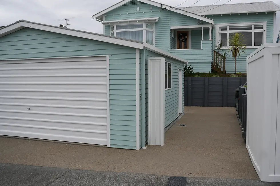 Exposed aggregate driveway leading to the garage below the raised house, Point Chevalier