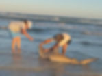 Two people handling a shark in Texas shark fishing photos.