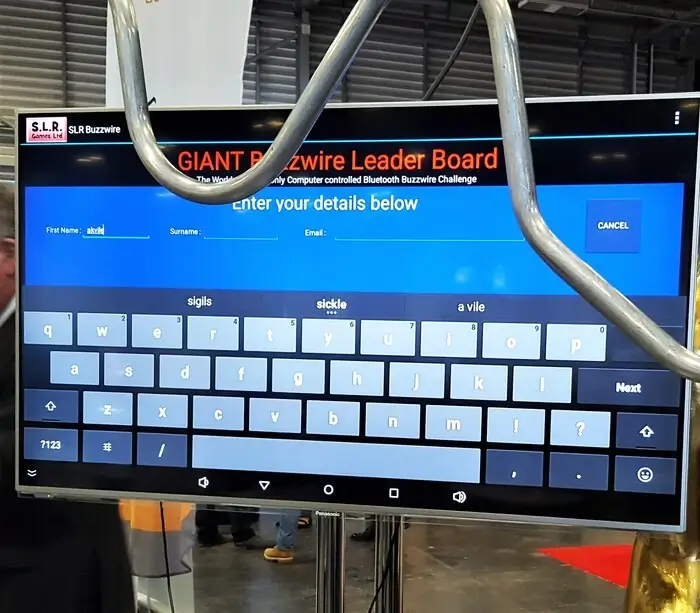 Giant beat the buzzer game in front of a large scree displaying the game app