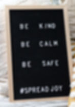 A sign: Be Kind, Be Calm, Be Safe, #Spread Joy