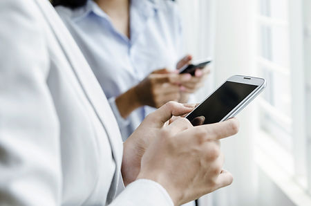 Two people texting on mobile phones