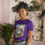Thumbnail: Woman smiling, wearing purple High Enlightenment Tee – Sacred Tokin’ Vibes t-shirt