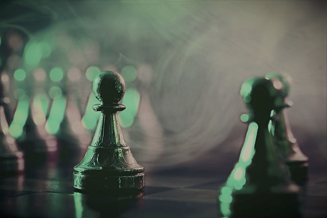 Chess pawns on checkerboard in color light, selective focus_edited_edited.jpg
