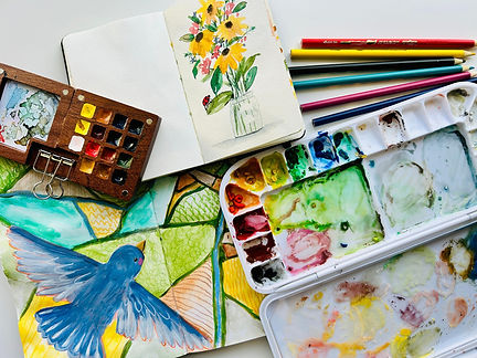 watercolor paints and sketchbooks