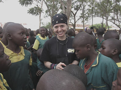 Chris Quintana surrounded by children during philantropic efforts.
