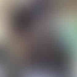 Client facing to the left showing her new hair colour and haircut, which is a long bob wavy, the hair colour is a dark brown going into black overall global hair colour