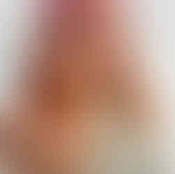 Client is facing to the right in front a white background showing her new haircolour, which is a pastel hair melt and pink roots