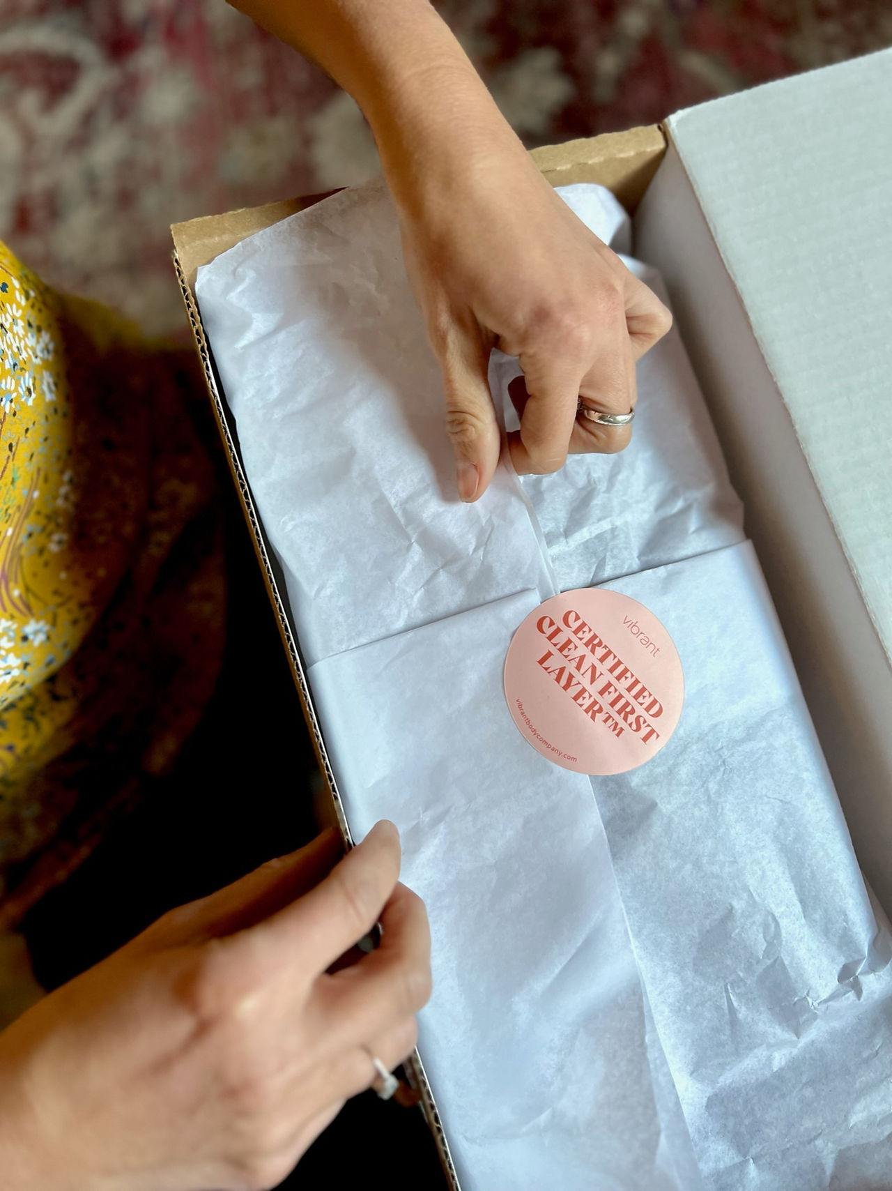 Opening a Vibrant Body Package. It's in a cardboard box with tissue paper