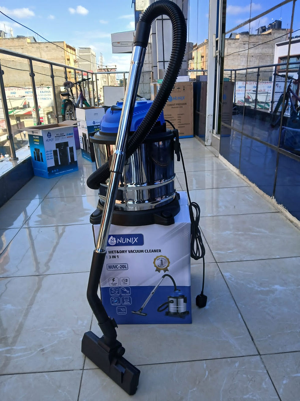 Blue and silver canister vacuum cleaner