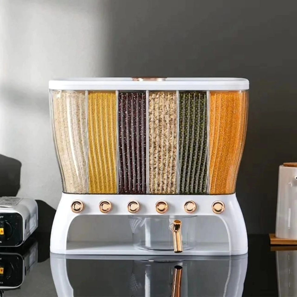A white and golden food dispenser with different dried ingredients.