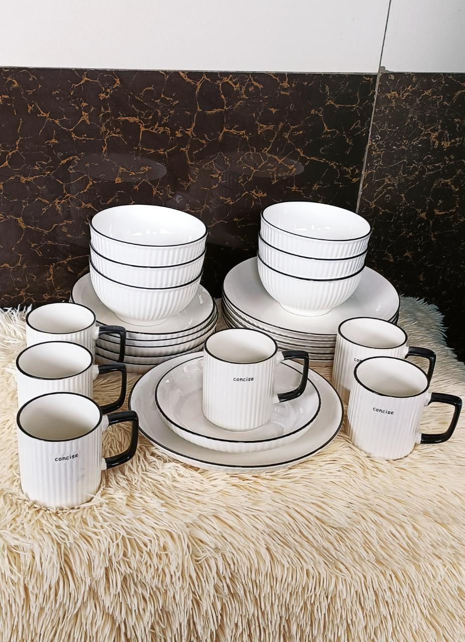 White ceramic dinnerware set with black rims