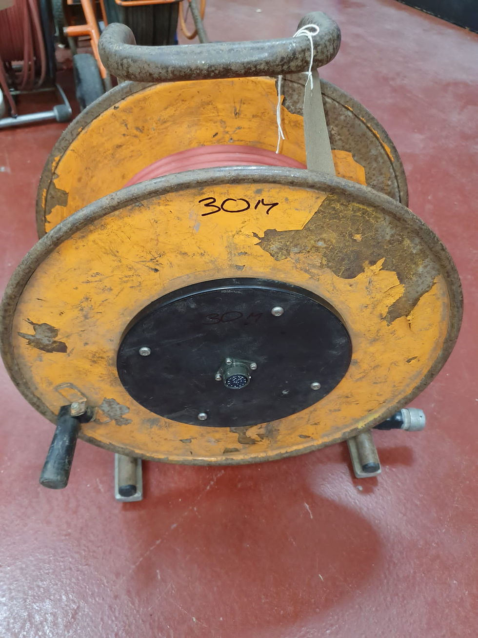 Side view of a used extension drum for an iPek drain camera inspection system