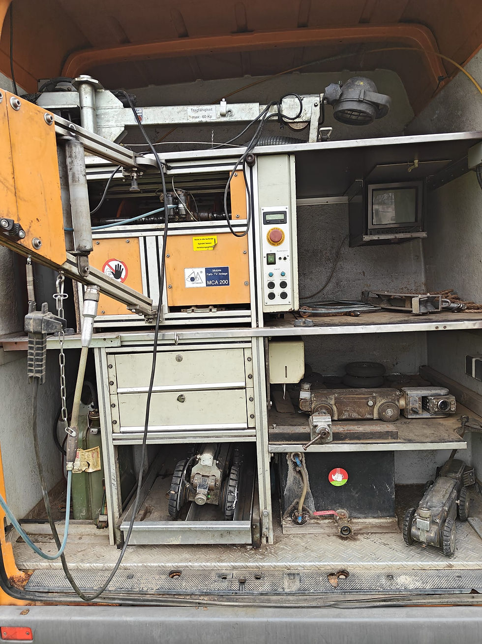 Thumbnail: A crawler inspection camera system that as been installed in a work's van