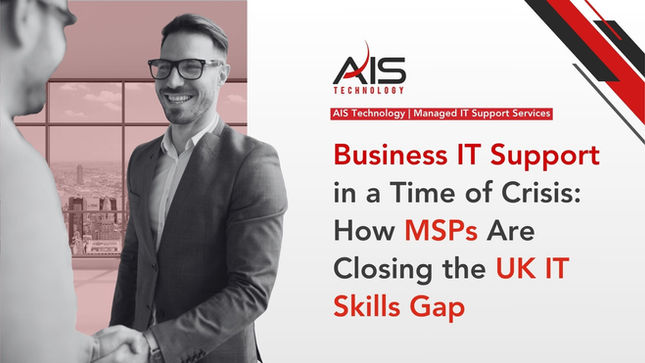Smiling man in a suit and glasses shakes hands in office with city view. Text reads: "Business IT Support...Closing the UK IT Skills Gap."