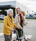 mature-granddaughter-carrying-grandmother