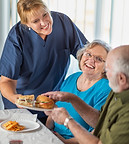 female-doctor-or-nurse-serving-senior-adult-couple